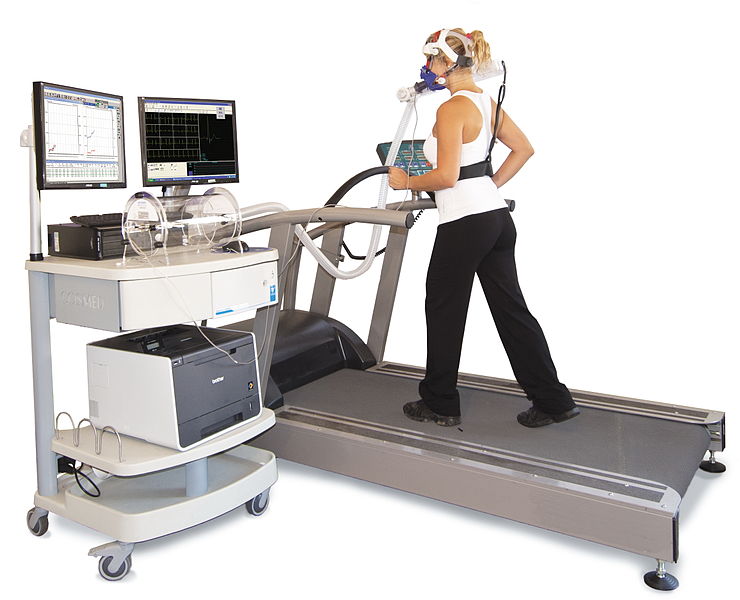 Person walking on a treadmill using a metabolic cart as a way to measure energy expenditure indirectly