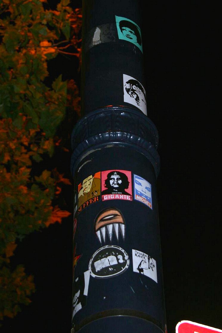 Shepard Fairey's Gigante sticker among other stickers on a lamp post. Photo: Caffeinatrix, CC BY-NC-ND 2.0.